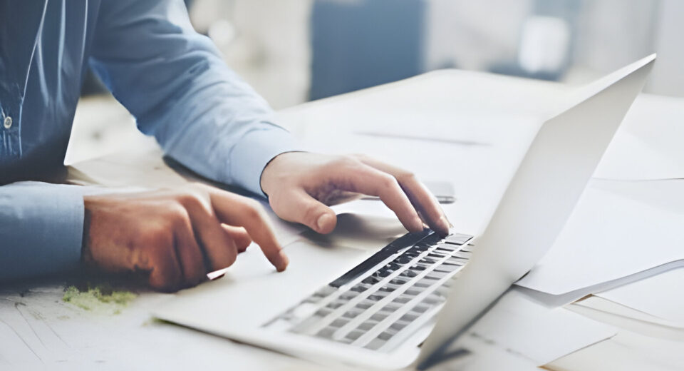 a person typing on a laptop